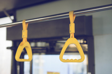 Handle on ceiling of bus train, MRT, prevent toppling.underground railway system or metro,selective focus,vintage color