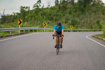Cycling competition,cyclist athletes riding a race at high speed on mountain road, Sportsmen bikes in the morning,vintage color,selective focus, sports concept,low angle view,Business competition