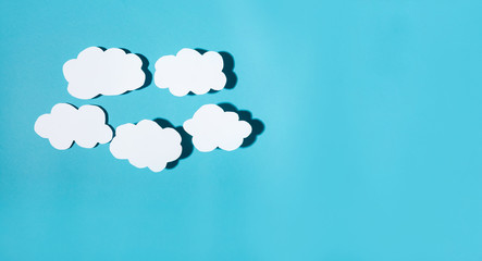 Paper cloud with hard shadow on a blue background