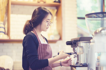 barista woman making latte art at coffee shop,equipment,cafeteria people and technology concept