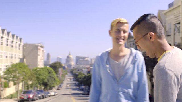 Asian Man Takes Photo Of His Boyfriend In The Middle Of The Street In San Francisco, Beautiful Views Behind Him