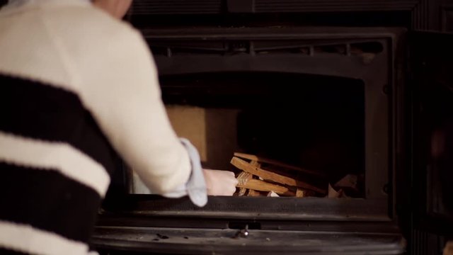 Woman Lights A Match And Then Starts A Fire In Fireplace