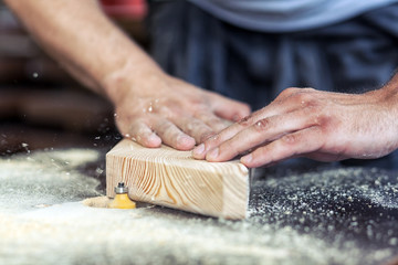 carpenter processes  wooden  with a milling machine