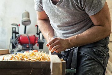 man work with a black jack plane