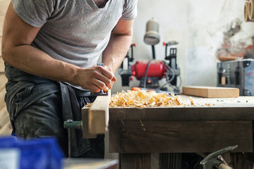man work with a black jack plane