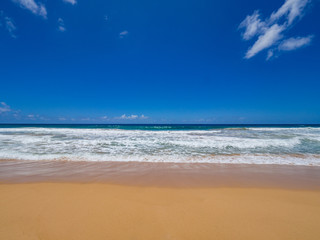 Fototapeta na wymiar Blue Sky, Golden Sand and Waves, Kealia Beach, Kapaa, Kauai, Hawaii, USA