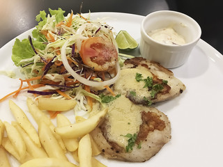 Selective focus on delicious food homemade fillet fish fried with fresh green salad ,french fried and white wine sauce.