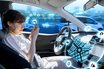 young woman using a smart phone in a autonomous car. driverless car. self driving vehicle. heads up...