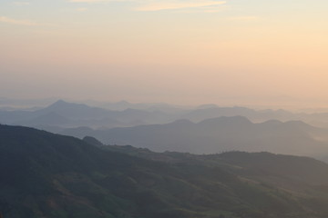 Fototapeta na wymiar Beautiful sunrise view in the mountains landscape at Lon Noi Cliff in Phurua National Park, Loei, Thailand.