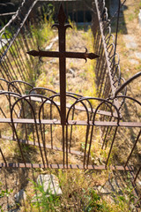 Grave with ornamental wrought iron border and latin cross