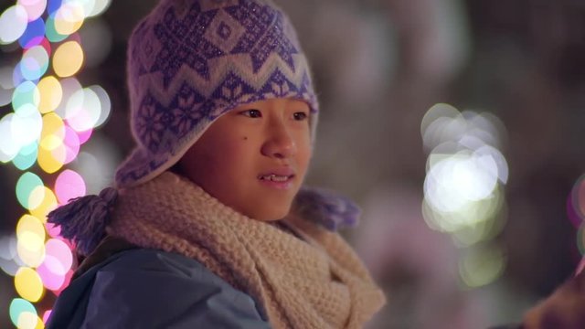 Little Girl Celebrates Winter Holidays With Sparkler, Holds It In Wonder (Slow Motion)