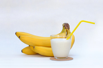 A bunch of bananas and a milkshake.