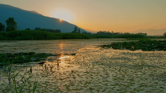 Morning sunrise time lapse above a lake, motorized slider HDR from RAW