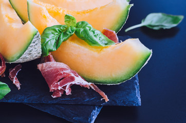 Concept of italian food with melon and prosciutto