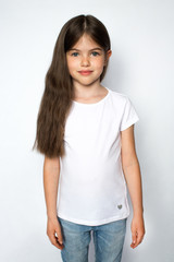 t-shirt design concept - smiling little girl in blank white t-shirt and blue jeans, isolated on a white background