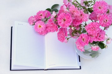 Beautiful flowers in a vase and opened the notebook.