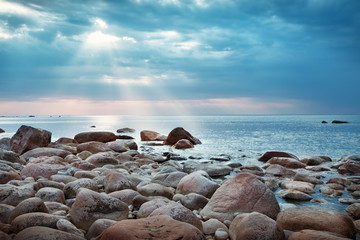 Rocky shores at the sea in sunset light. Lahemaa natural park coastal landscape with beautiful sky