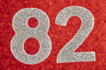 Number eighty-two silver color over a red background. Anniversary.