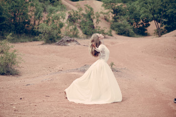 Beautiful ballerina or bride posing outdoor