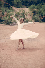Fototapeta na wymiar Beautiful ballerina or bride posing outdoor