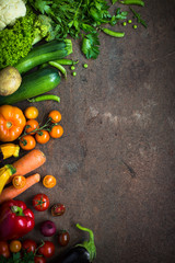 Organic farmer vegetables on dark slate table. Vegan food.