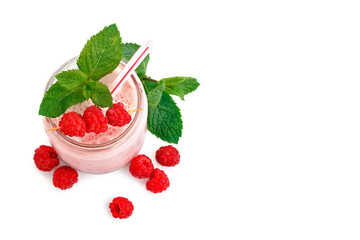 Mug of raspberry smoothie and berries of ripe raspberry on a white background.