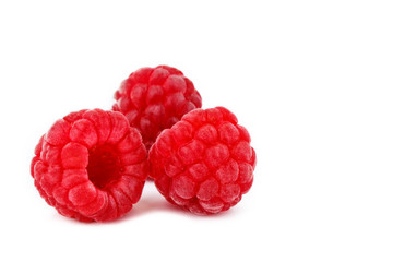 Tasty ripe raspberries on a white background.