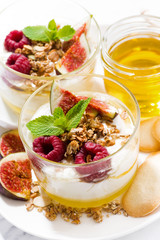 sweet yogurt with honey, raspberries and fresh figs, vertical closeup