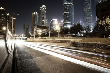 Fototapeta na wymiar Empty road surface with city landmark buildings of night