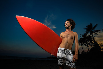  Man in swimsuit holding a surfboard