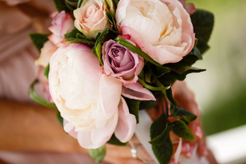 Beautiful wedding bouquet in hands of the bride