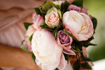 Beautiful wedding bouquet in hands of the bride
