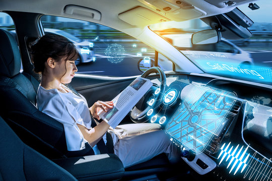 young woman using a smart phone in a autonomous car.  self driving vehicle. heads up display. automotive technology.