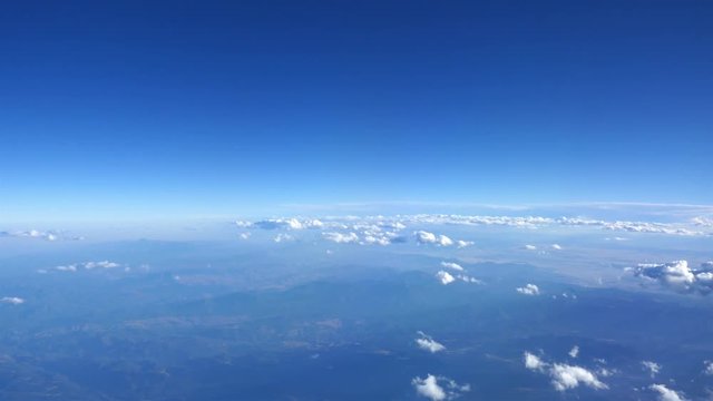 Aerial shot above the clouds of mountains in 4K