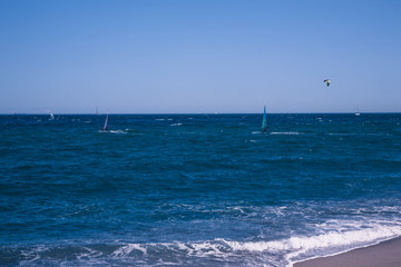 Wind surfers on the blue sea