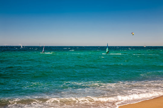 Wind surfers on the blue sea