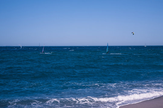 Wind surfers on the blue sea