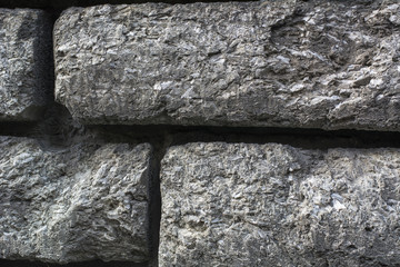 Grey old granite stones closeup