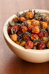Dried rose hips in wooden bowl