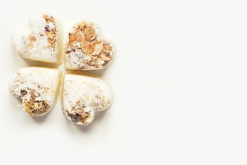 Herbal heart bath bombs on a white background. Copy space