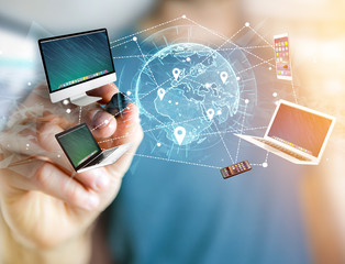 Computer and devices displayed on a futuristic interface with interantional network - Multimedia and technology concept