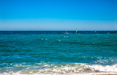 Fototapeta premium Wind surfers on the blue sea
