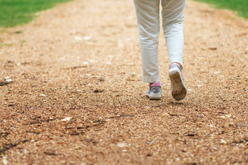 Young woman running on a rough road.