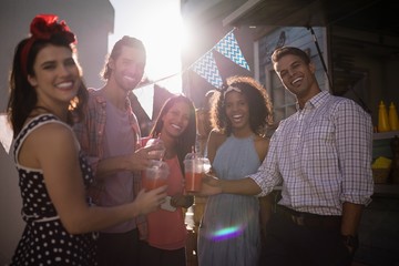 Happy friends toasting glasses of juice