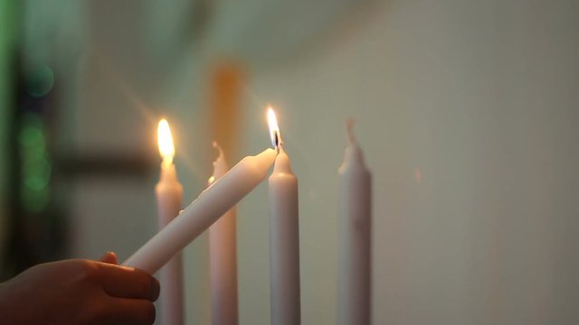 Waiter lights the candles