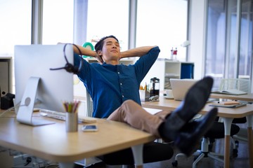 Male executive relaxing at his desk