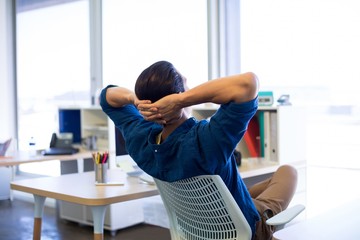 Male executive relaxing at his desk