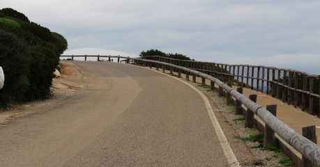 Fototapeta premium A road in the countryside against a cloudy grey sky