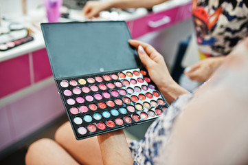 Close-up photo of eyeshadow palette in the salon.