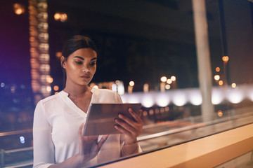 Businesswoman inside the airport lounge using digital tablet